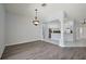 Open dining area with wood-look floors and an elegant chandelier at 16862 Se 80Th Bellavista Cir, The Villages, FL 32162