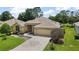 Charming single-story home with a well-manicured lawn and a paved driveway leading to a two-car garage at 16862 Se 80Th Bellavista Cir, The Villages, FL 32162
