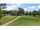 Scenic golf course view showcasing lush green fairways and mature trees on a sunny day at 16862 Se 80Th Bellavista Cir, The Villages, FL 32162