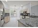 Spacious kitchen showcasing granite countertops, stainless steel appliances, and modern cabinets at 16862 Se 80Th Bellavista Cir, The Villages, FL 32162