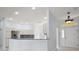 Open-concept kitchen with granite countertop, stainless-steel refrigerator, white cabinets, and tile floors at 16862 Se 80Th Bellavista Cir, The Villages, FL 32162