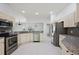 Modern kitchen with granite counters, stainless appliances, white cabinets, and views of the eating area at 16862 Se 80Th Bellavista Cir, The Villages, FL 32162