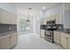 Bright and airy kitchen with a stainless-steel oven, white cabinets, and a window at 16862 Se 80Th Bellavista Cir, The Villages, FL 32162
