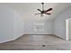 Bright living room with ceiling fan, light-colored walls and gray wood-look flooring at 16862 Se 80Th Bellavista Cir, The Villages, FL 32162