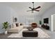 Living room with wood flooring, ceiling fan, large window, neutral decor, and comfortable furnishings at 16862 Se 80Th Bellavista Cir, The Villages, FL 32162