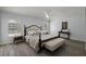 Spacious main bedroom showcasing wood floors, fan, and elegant furniture at 16862 Se 80Th Bellavista Cir, The Villages, FL 32162