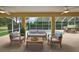 Covered patio seating area overlooking a screened-in pool and landscaped yard at 16862 Se 80Th Bellavista Cir, The Villages, FL 32162