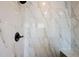 Modern shower featuring sleek marble tiling and bronze fixtures adding a touch of elegance at 16862 Se 80Th Bellavista Cir, The Villages, FL 32162
