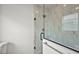 This walk-in shower has marble tiling, frameless glass doors and bronze hardware at 16862 Se 80Th Bellavista Cir, The Villages, FL 32162