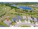 An aerial view featuring a home's location near scenic ponds, lush greenery, and well-planned community layout at 1696 Wilson Prairie Cir, Groveland, FL 34736