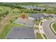 An aerial view showing a beautifully landscaped home with a spacious backyard and nearby pond at 1696 Wilson Prairie Cir, Groveland, FL 34736