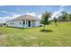 The backyard showcases a well-manicured lawn and landscaping, providing a serene outdoor space for relaxation and enjoyment at 1696 Wilson Prairie Cir, Groveland, FL 34736