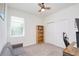 Comfortable bedroom with cozy sofa, ceiling fan and ample sunlight at 1696 Wilson Prairie Cir, Groveland, FL 34736
