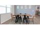 Dining room features a stunning wood table with clear resin inlay and decorative chairs by a window at 1696 Wilson Prairie Cir, Groveland, FL 34736