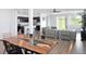 Bright open-concept living space with a modern kitchen, dining area, and comfortable gray sectional sofa at 1696 Wilson Prairie Cir, Groveland, FL 34736