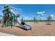 A spacious playground offers swings and a tall slide on a wood chip surface for a safe and fun environment at 1696 Wilson Prairie Cir, Groveland, FL 34736