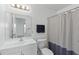Bathroom featuring a vanity sink, mirror, toilet and shower with shower curtain at 1726 Tropical Ct, Tavares, FL 32778