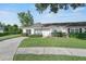Charming single-story home featuring a well-maintained lawn and inviting curb appeal at 1726 Tropical Ct, Tavares, FL 32778
