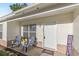 Cozy front porch with seating, decorative welcome mat, and tasteful decor at 1726 Tropical Ct, Tavares, FL 32778
