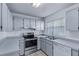 Bright kitchen featuring grey cabinets, modern appliances, and ample counter space at 1726 Tropical Ct, Tavares, FL 32778