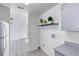 Conveniently located laundry hookups in the kitchen with gray cabinets and shelf space at 1726 Tropical Ct, Tavares, FL 32778