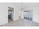 Open-concept living room with tile floors leads to a galley kitchen and outdoor views at 1726 Tropical Ct, Tavares, FL 32778
