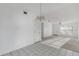 Bright living room with tile flooring, modern lighting and access to carpeted living space at 1726 Tropical Ct, Tavares, FL 32778