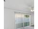 Well-lit bedroom features a sliding door to the backyard and bright natural light at 1726 Tropical Ct, Tavares, FL 32778