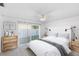 Comfortable bedroom features a plush bed, stylish décor, and sliding door to backyard at 1726 Tropical Ct, Tavares, FL 32778
