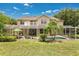 The backyard features a screened-in pool and patio, lush plants, and ample space for outdoor entertaining at 17300 Summer Sun Ct, Clermont, FL 34711