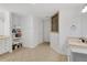 This bathroom is crisp and clean with all white finishes and white tile flooring at 17300 Summer Sun Ct, Clermont, FL 34711