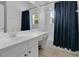 This bathroom has tile floors, white cabinets and vanity, and a shower/tub combo at 17300 Summer Sun Ct, Clermont, FL 34711