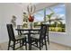 Cozy dining area with pendant lighting and large windows showcasing the serene outdoor views at 17300 Summer Sun Ct, Clermont, FL 34711