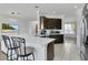 Modern kitchen featuring stainless steel appliances, quartz countertops, and breakfast bar at 17300 Summer Sun Ct, Clermont, FL 34711