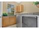 Clean laundry room featuring modern washer and dryer, cabinets, and tile flooring at 17300 Summer Sun Ct, Clermont, FL 34711