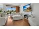 Bright living room featuring contemporary furniture, fireplace, and sliding glass doors to the exterior at 17300 Summer Sun Ct, Clermont, FL 34711