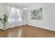 Bright living room with wood floors, large windows, and modern light fixture and decorative wall art at 17300 Summer Sun Ct, Clermont, FL 34711