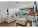 Spacious living room with modern lighting, comfortable seating, and view of outdoor space at 17300 Summer Sun Ct, Clermont, FL 34711