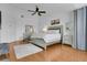 This main bedroom offers a ceiling fan and a light wood floor and contemporary furniture at 17300 Summer Sun Ct, Clermont, FL 34711