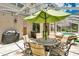 Relax on the outdoor patio, complete with ample seating, a grill, and a view of the screened-in pool at 17300 Summer Sun Ct, Clermont, FL 34711