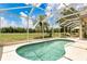 Relaxing screened-in swimming pool with lush landscaping and outdoor seating area at 17300 Summer Sun Ct, Clermont, FL 34711