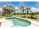 Relaxing screened-in swimming pool with lush landscaping and outdoor seating area at 17300 Summer Sun Ct, Clermont, FL 34711