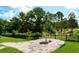 Landscaped backyard with a stone patio and lush green surroundings at 18008 Victorian Dr, Clermont, FL 34715