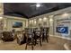 Basement entertainment room featuring a large TV, a bar-height table, chairs, and Tampa Bay Lightning decor at 18008 Victorian Dr, Clermont, FL 34715