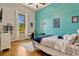 Inviting bedroom with a comfortable bed, wooden floors, and large windows providing natural light at 18008 Victorian Dr, Clermont, FL 34715