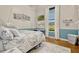 Bright bedroom featuring a hanging chair, modern decor, and light blue accent wall at 18008 Victorian Dr, Clermont, FL 34715