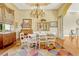 Cozy dining room featuring colorful rug, chandelier, and adjacent kitchen at 18008 Victorian Dr, Clermont, FL 34715