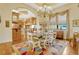 Bright dining room featuring colorful rug, chandelier, and adjacent gourmet kitchen at 18008 Victorian Dr, Clermont, FL 34715