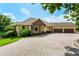 Beautiful single-Gathering home with a brick paver driveway and a spacious three-car garage at 18008 Victorian Dr, Clermont, FL 34715