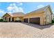 Attractive home with a three-car garage, brick paver driveway, and a charming stone facade at 18008 Victorian Dr, Clermont, FL 34715